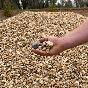 Pictured here is a bulk pile of 3/4" - 1-3/4" with a hand holding a few stones to visualize the size better. Elkin Lawn and Garden is your source for river rock. This stone offers natural tones of Brown and Tan. This NC River Rock is irregular shape and smoothed by the natural source of water from our local rivers. Perfect for landscaping beds, dry creek beds, walkways and more.